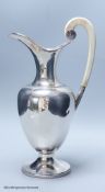 A German ivory handled 800 standard white metal vase shaped ewer, with presentation inscription,