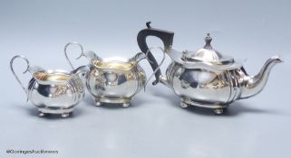 A Scottish silver three-piece tea service, of ribbed, bellied oval form,comprising teapot, cream