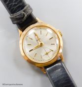 A lady's 9ct gold Tudor manual wind wrist watch, with subsidiary seconds, on a leather strap, with