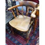 A Victorian elm and beech smokers bow elbow chair, together with a later mahogany desk chair.