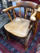 A Victorian elm and beech smokers bow elbow chair, together with a later mahogany desk chair.