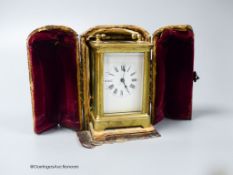 A brass cased carriage timepiece, 7.5cm, in a leather carrying case,