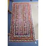 A Caucasian design Boteh red ground rug, 236 x 116cm