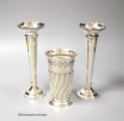 A late Victorian wrythened fluted silver vase, 13cm, 153 grams and a pair of later silver spill