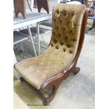 A Victorian mahogany slipper chair.