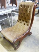 A Victorian mahogany slipper chair.