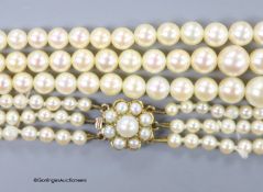 A triple strand graduated cultured pearl choker necklace, with a 9ct and cultured pearl cluster set