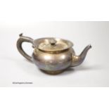 An Edwardian silver bachelor's squat circular teapot, T. Wooley, Birmingham, 1909, gross 9.5oz.