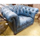 Victorian style, buttoned blue leather chesterfield armchair.