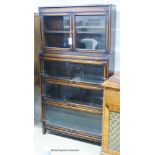 A Globe Wernicke style oak four section bookcase, length 86cm, depth 24cm, height 161cm