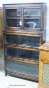 A Globe Wernicke style oak four section bookcase, length 86cm, depth 24cm, height 161cm