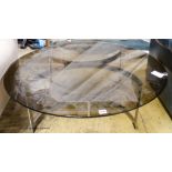 A Merrow style circular glass top table. D-100cm, H-32cm.