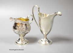 A George III silver inverted pear shaped cream jug, with later embossed decoration, marks rubbed,