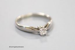 A modern 14ct white gold and solitaire diamond set ring, the stone weighing 0.15ct, size L, gross