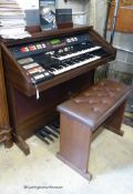 A Hammond organ, XT-100/XH-200 with stool and a quantity of music books. W-125.