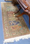 A Turkish multi mirab prayer rug. Woven with animals among trees. 220x86cm.