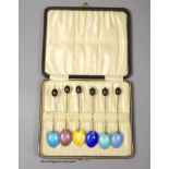 A late 1920's cased set of six continental silver and enamel bean end coffee spoons, import marks