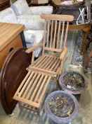 A pair of brass mounted teak garden steamer chairs