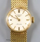 A lady's 9ct gold Longines manual wind wrist watch, on a 9ct gold bracelet, case diameter 20mm,