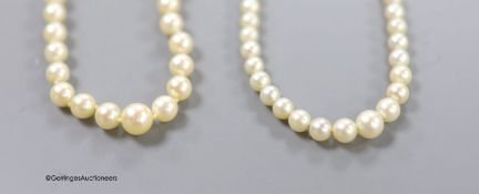 Two single strand graduated cultured pearl necklaces, one with 14k white metal clasp,45cm, the