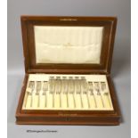 An Edwardian cased set of twelve pairs of ivory handled silver fish eaters, by Mappin & Webb,