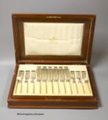 An Edwardian cased set of twelve pairs of ivory handled silver fish eaters, by Mappin & Webb,