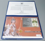 A 2003 gold bullion sovereign presented in a Coronation Jubilee cover, with certificate of