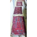 Three Belouch red ground rugs, largest 110 x 70cm