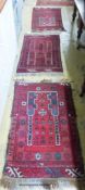 Three Belouch red ground rugs, largest 110 x 70cm
