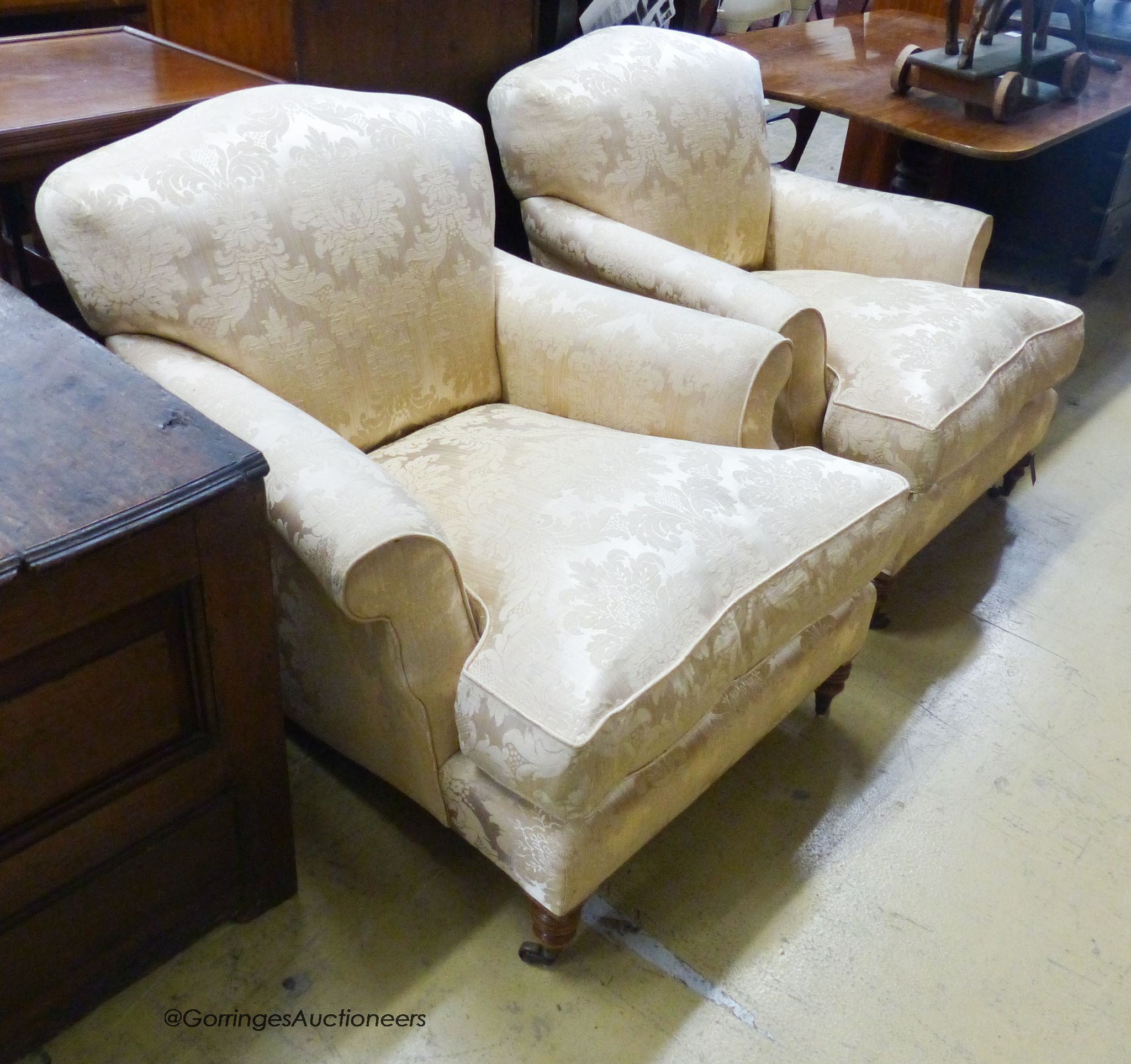 A pair of Howard style cream brocade upholstered lounge armchairs, width 85cm, depth 100cm, height