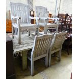 A weathered teak extending dining table, extended 250cm, depth 120cm, height 75cm and six chairs