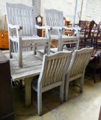 A weathered teak extending dining table, extended 250cm, depth 120cm, height 75cm and six chairs