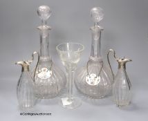 A pair of glass decanters with enamelled labels, 32cm, a pair of cut glass vinegar bottles and a