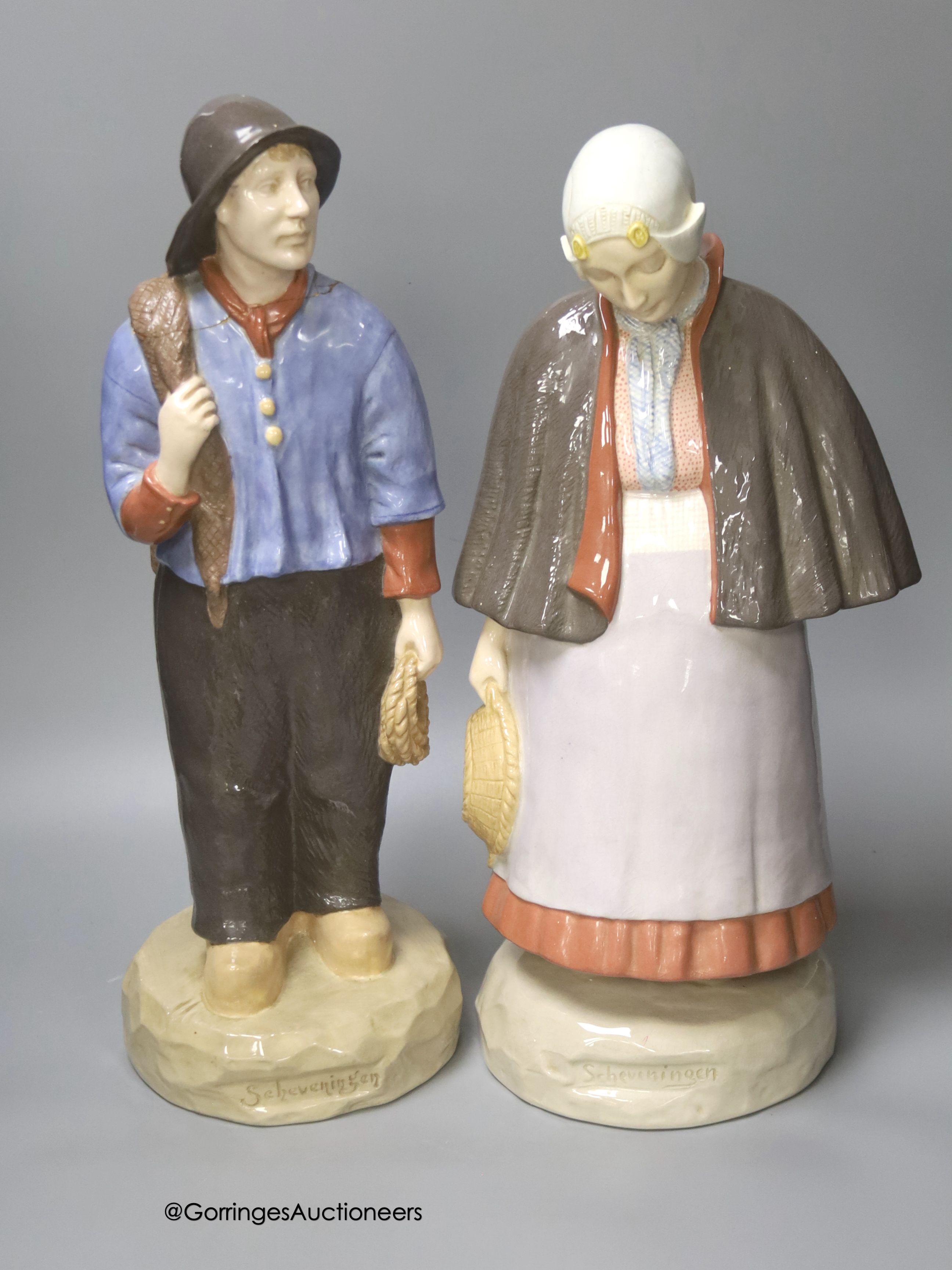 A pair of large Gouda pottery figures of a fisherman and fisherwoman, entitled 'Scheveningen', 41cm