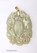 A Chinese yellow metal amounted jade pendant, 63mm, carved with dragons and character marks.