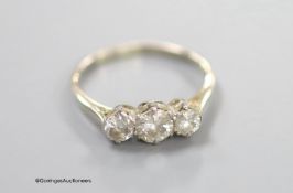 An 18ct and three stone diamond set ring, size P, gross weight 2.3 grams,the central stone weighing