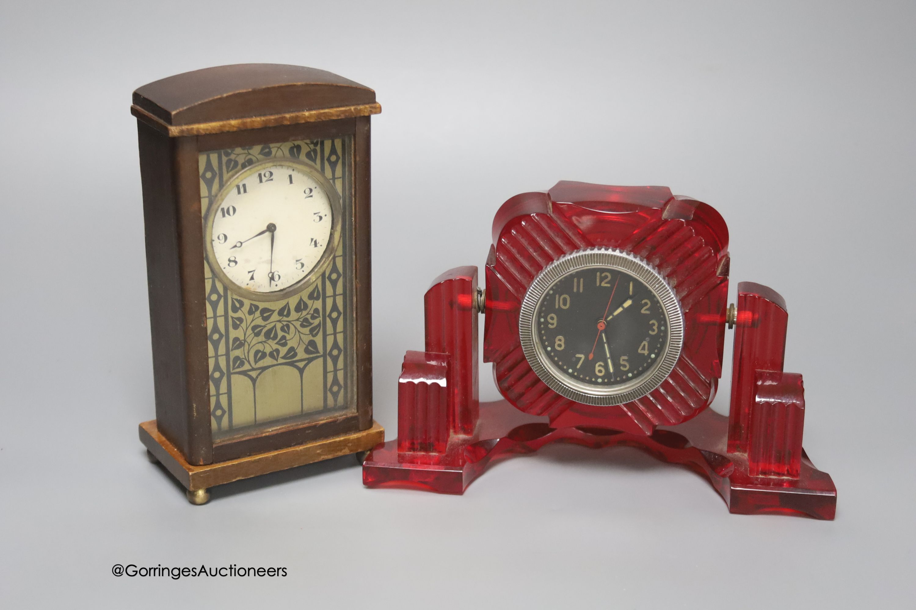 A Russian moulded red acrylic mantel timepiece, width 19cm, and a Secessionist style beech cased