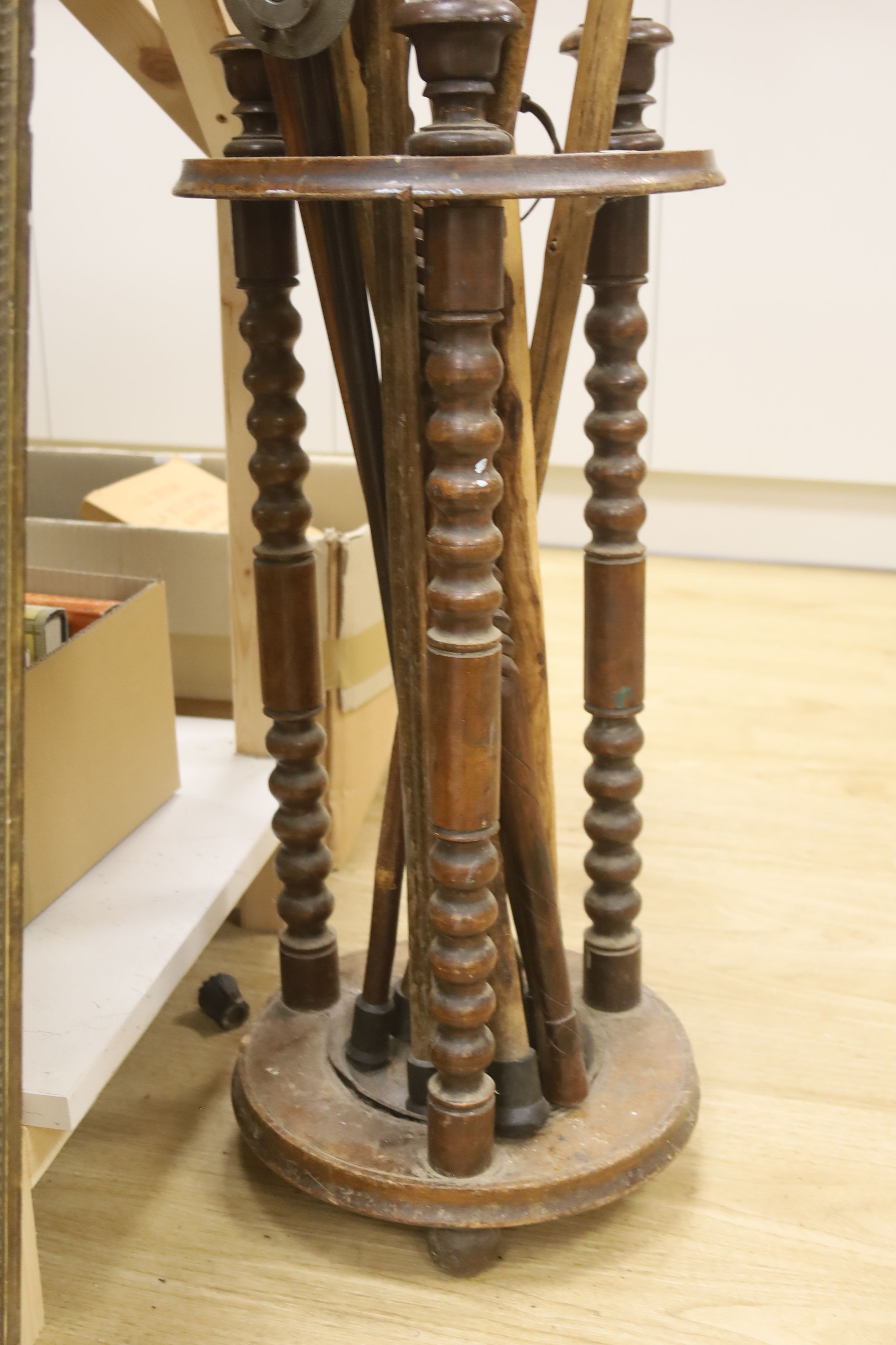 A circular turned beech stick stand, containing various walking sticks and a shooting stick - Image 5 of 5