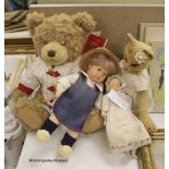 A modern Kathe Kruse doll with Burlington Berties cot and modern china baby doll and Harrods bear