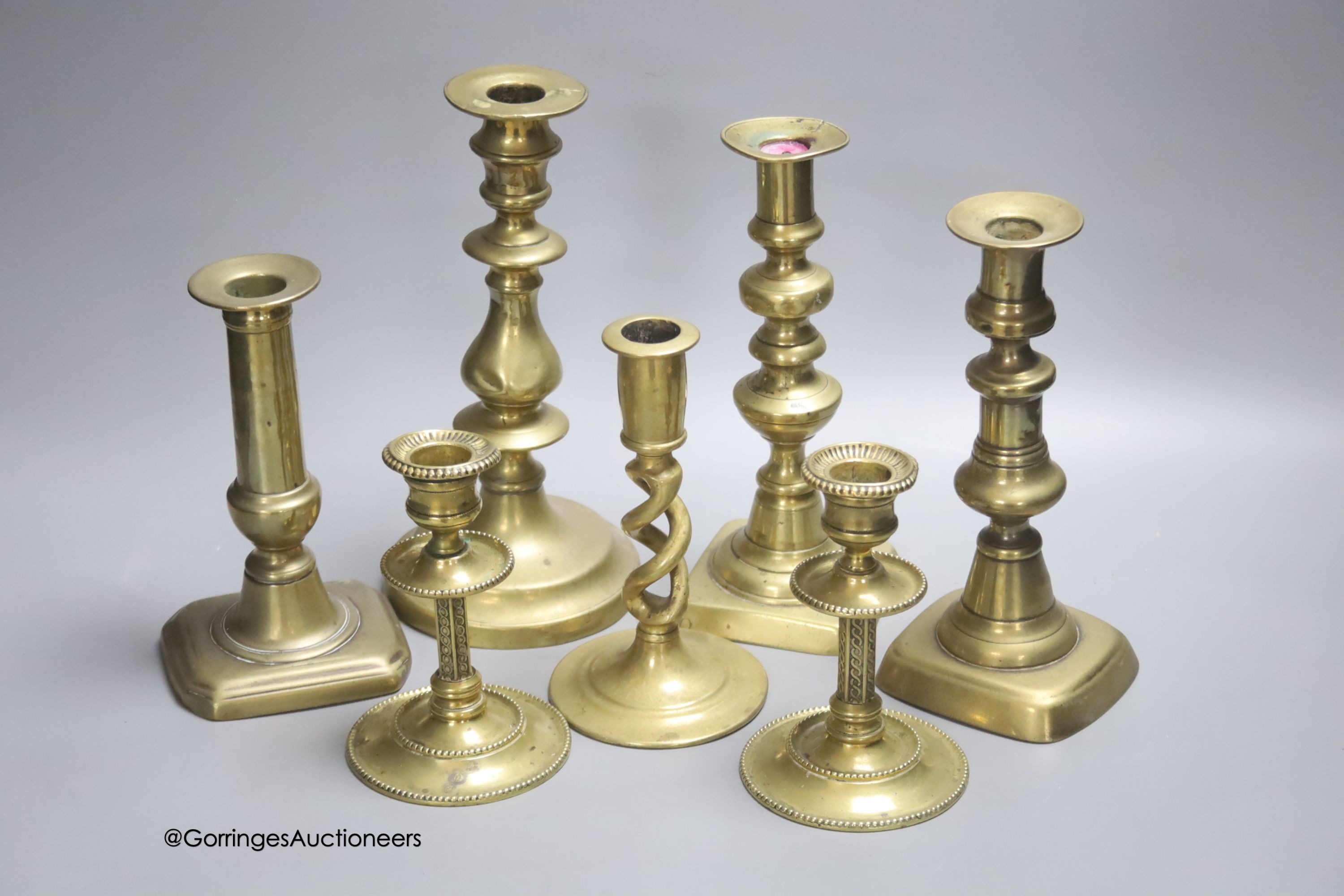 A quantity of brass candlesticks