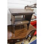 An early 20th century solid, dark oak occasional table with folding top and undertier, width 56cm,