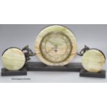 An Art Deco slate and onyx 'antelope' clock garniture, length of central piece 44cm
