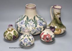 Three Cobridge floral vases and a jug and vase with plum design, tallest 21cm