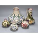 Three Cobridge floral vases and a jug and vase with plum design, tallest 21cm