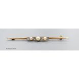 A stylish 14k gold diamond and pearl bar brooch, gross 4.5g, 7cm.