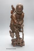 An early 20th century Chinese hardwood carving of a luohan figure, height 52cm