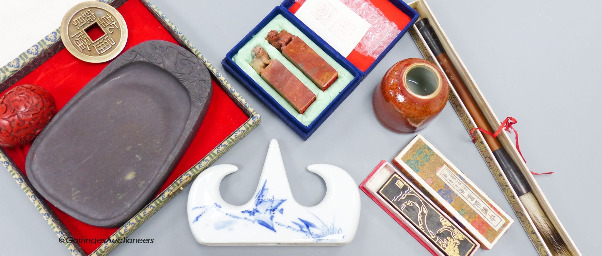 A Chinese inkstone and other calligraphy related items