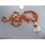 A jagged coral bead necklace, with jade pendant, carved as a fish, necklace approx. 88cm, fish