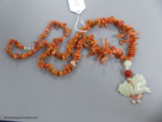 A jagged coral bead necklace, with jade pendant, carved as a fish, necklace approx. 88cm, fish