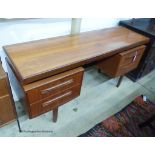 A mid century design G plan teak dressing table, length 152cm, depth 46cm, height 70cm